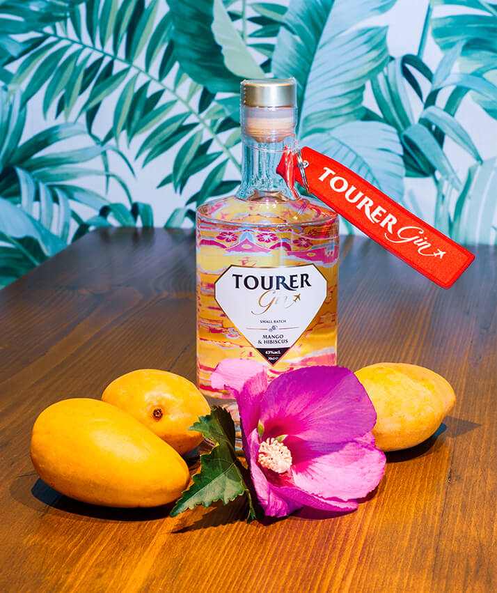 Tourer mango gin with fresh mango and hibiscus flower